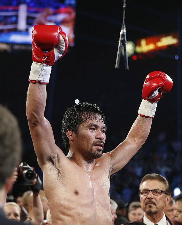 Manny Pacquiao, of the Philippines, celebrates after defeating Timothy Bradley in their WBO welterweight title boxing bout Saturday, April 9, 2016, in Las Vegas. (AP Photo/Isaac Brekken)