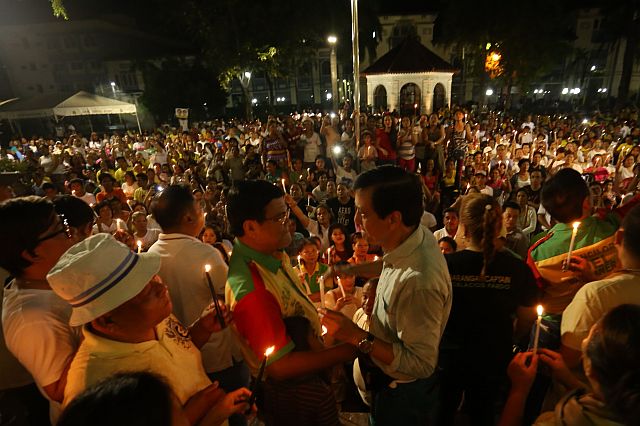 Cebu City Mayor Michael Rama and Vice Mayor Edgar Labella share light moment during their candle lighting infront of Cebu City hall. (CDN PHOTO/LITO TECSON)