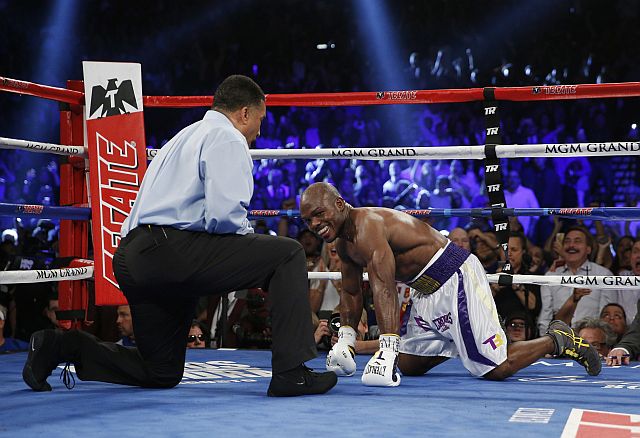 Timothy Bradley kneels on the mat after getting hit by Manny Pacquiao, of the Philippines, during their WBO welterweight title boxing bout Saturday, April 9, 2016, in Las Vegas. (AP Photo/John Locher)