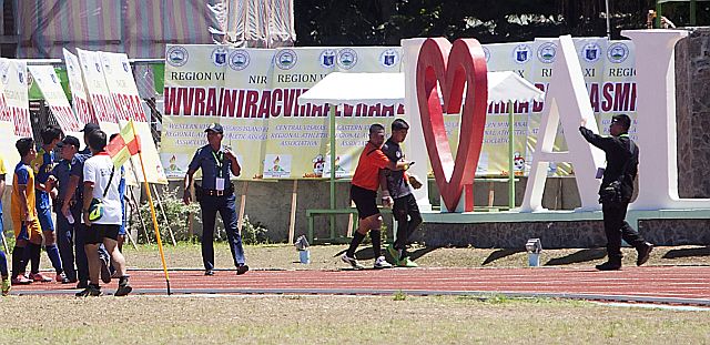 PALARONG PAMBANSA 2016: Police and tournament officials restrain NCR booters from chasing Goalie Josep Ceniza of Central Visayas after a commotion with NCR booter in the Palarong Pambansa secondary boys final. NCR won the match 2-1.(CDN PHOTO/TONEE DESPOJO)