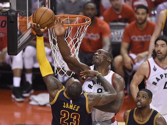 Toronto Raptors center-forward Bismack Biyombo, center right, picks up a foul as he stops Cleveland Cavaliers forward LeBron James during the second half of Game 3 of the NBA basketball Eastern Conference finals in Toronto on Saturday, May 21, 2016. (Frank Gunn/The Canadian Press via AP) MANDATORY CREDIT