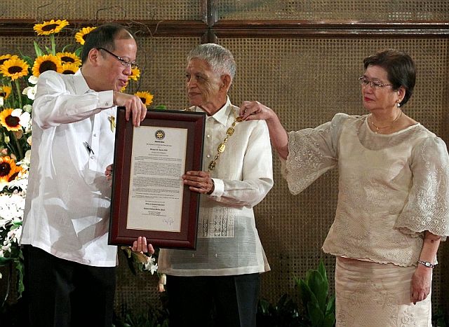 President Benigno S. Aquino III confers the Order of National Scientist on Dr. Ramon Barba, PhD. during the conferment ceremony at the Rizal Hall of the Malacañan Palace on Tuesday (August 12, 2014). Dr. Barba received the Presidential Medallion for his distinguished achievements in the field of plant physiology, focusing on induction of flowering of mango and on micropropagation of important crop species that have earned him national and international accolades. His pioneering work on the induction of flowering and fruiting of mango resulted in the change from seasonal supply of fresh fruits to all year round availability of abundant fresh mangoes.  The regularity of mango production is the key ingredient in the development of mango exports which gave rise to an entirely new industry of processed mango products. He developed the plant growth enhancer, FLUSH, which accelerates the growth cycle of the trees and advance their flowering and fruiting stages, to assure continuous fruit bearing of mango trees. The Order of National Scientist is the highest honor given by the President of the Republic of the Philippines to a Filipino man or woman of science in the Philippines who has made significant contributions in one of the different fields of science and technology. Also in photo is Dr. Corazon Veron Cruz-Barba. (Photo by Gil Nartea / Malacañang Photo Bureau)