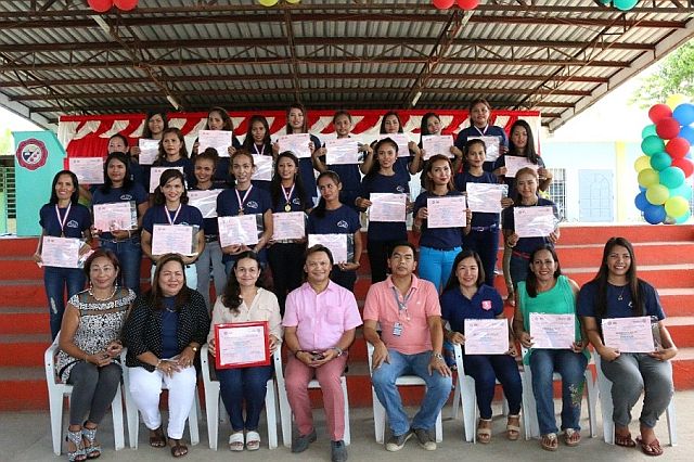 The 23 mothers and young ladies from Naga City display their certificates after completing the beauty care courses offered by Kepco. (CONTRIBUTED)