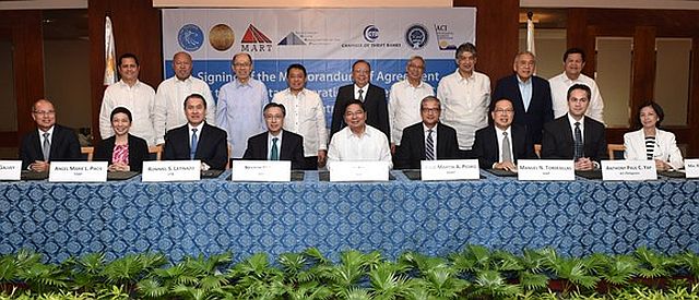 Bangko Sentral ng Pilipinas Governor Amando M. Tetangco, Jr. (seated center) led the signing of the Memorandum of Agreement for the Monetary Operations System of the BSP, a web-based electronic platform that will enable counterparties to participate in the BSP’s new auction-type facilities under the Interest Rate Corridor (IRC) System. The IRC will improve the transmission of monetary policy by helping ensure that the money market rates move within a reasonably close range around the BSP’s policy rate. (bsp.gov.ph)