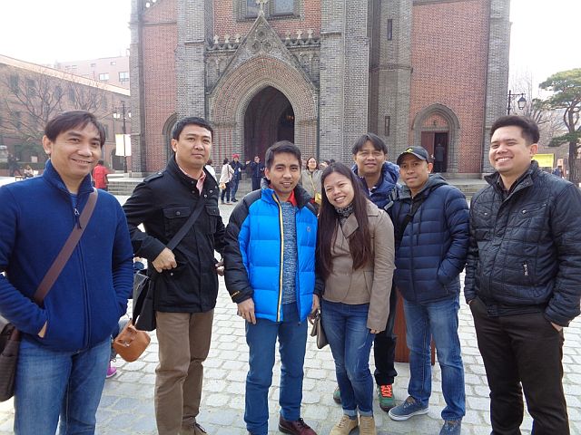 (From Left) Cebuano engineers Jues Optina, Bryan Alforque, Jaydie Castro, Faye Gantuangko, Quintiano Roiles, Melodino Alao and Alvin Jumamil strike a pose for CDN after the Easter Sunday mass at Myeondong Cathedral in Seoul. (Photo by: Frauline Sinson)