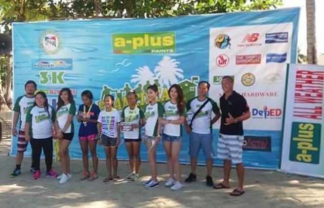 Winners in the women’s 10k division are joined by organizers and sponsors during the awarding ceremony. (CONTRIBUTED)