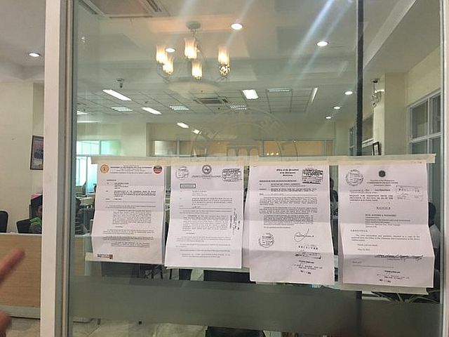 The mayor's staff refused to officially receive the copy of the order which prompted the regional DILG-7 officials to just post the order on the glass door leading to the mayor's office at 10:30 am. (CDN PHOTO/JOSE SANTINO S. BUNACHITA)