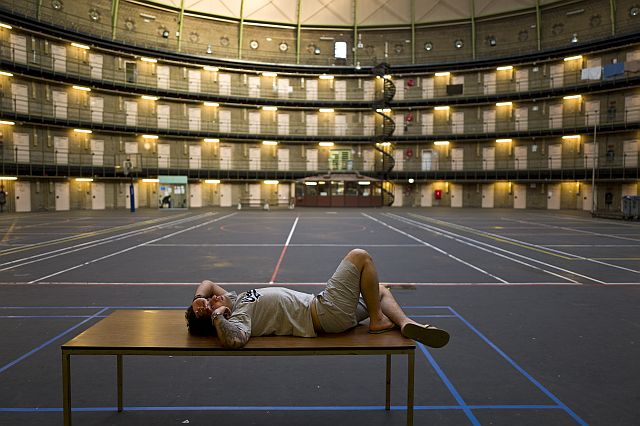 In this Friday, May 6, 2016 photo, Iranian migrant Reda Ehsan, 25, lies on a table at the former prison of De Koepel in Haarlem, the Netherlands. With crime declining in the Netherlands, the country is looking at new ways to fill its prisons. (AP)