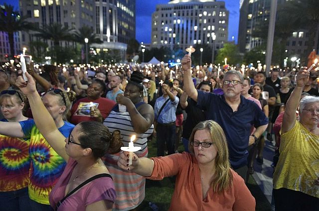 People hold candles during a vigil for the victims of the Pulse nightclub shooting in Orlando, Florida. (AFP)