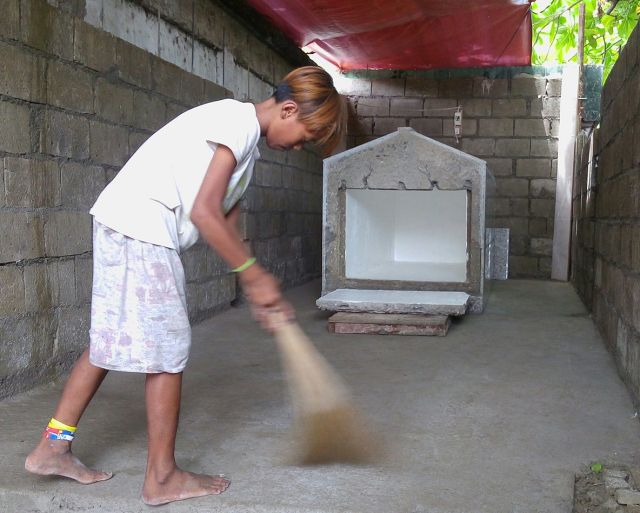 A boy sweeps the floor of the mausoleum as he prepares the final resting place of Jeffrey “Jaguar” Diaz. Diaz was buried yesterday at the Calamba Public Cemetery. (CDN PHOTO/TONEE DESPOJO)