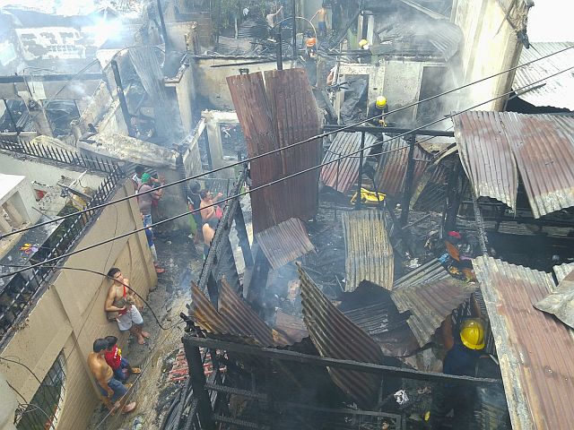 Firemen tend to affected houses at Barangay Labangon.
