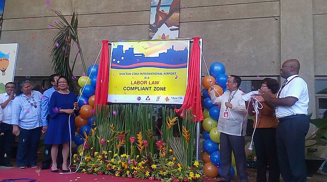 MARKER. Labor Secretary Rosalinda Baldoz and Mactan Cebu International Airport  General Manager Nigel Paul Villarete unveil the labor law compliance marker at the MCIA departure area. (CDN PHOTO/APPLE MAE TA-AS)
