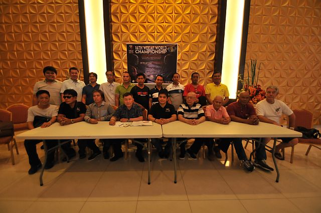 Organizers of the upcoming 14th Wekaf World Championship, led by Dionisio Cañete (seated, 4th from right), chairman emeritus of Wekaf, pose after a press briefing yesterday at JCentre Mall.