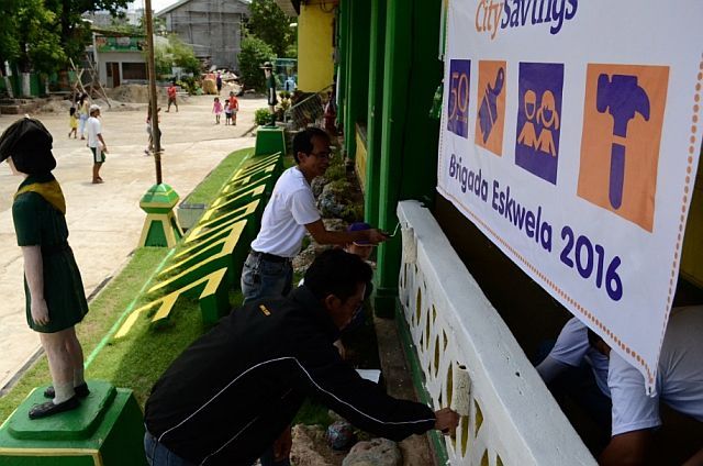 CitySavings head office team members repaint the corridor fence of Zapatera Elementary School in Cebu City. (CONTRIBUTED)
