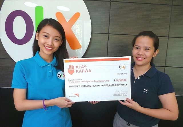 OLX marketing officer Trish Janel Jao turns over the check worth over P16,000 to Maria Pamela Villegas, Corporate Engagement Specialist of World Vision. (CONTRIBUTED)