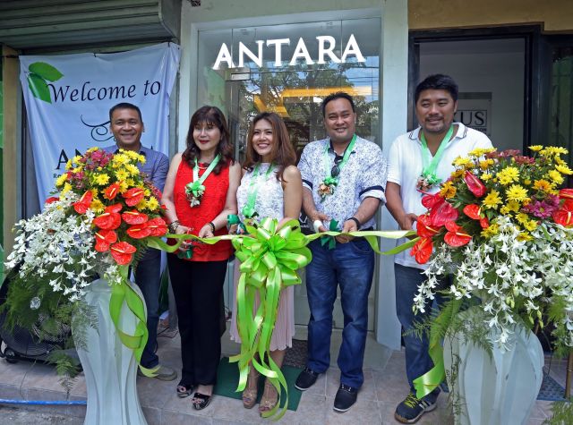 Officials of Nexus Real Estate Corp. led by Rosita Lopez, Nexus chairperson, and Shanna Lopez, Nexus CEO, (right photo, second and third from left)  launch its Antara showroom along N. Bacalso Avenue. Manuel Roledo, (left) Nexus’ vice president for marketing, was also present in the event. Above is the artist’s sketch of the Antara 1, the first tower in the 5-tower project in Talisay City. (CDN PHOTO/LITO TECSON)
