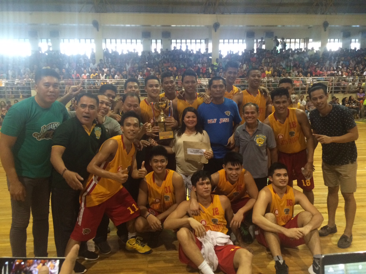 The University of San Jose-Recoletos Jaguars celebrate at centercourt after bagging the third place trophy of the Mayor Kim Lope A. Asis 1st Collegiate Invitational Basketball Tournament. (CDN PHOTO/CALVIN D. CORDOVA)