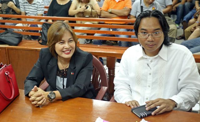 Cebu City Asst. Prosecutor Mary Ann Castro is all smiles as she is accompanied by her lawyer,  Vesmind Santiago, during their hearing at the sala of Judge Francisco Seville of the MTCC Branch 7. (CDN PHOTO/LITO TECSON)