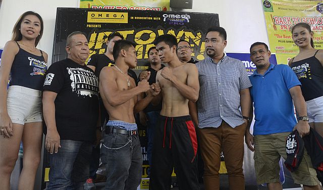 Jason Canoy (2nd from left) and Jestoni Autida in a staredown after their weigh-in for their main event encounter of tonight’s Uptown Rumble in One Mango Avenue, Cebu City. Yesterday’s weigh-in held at Pino Plaza was attended by officials of Omega Pro Sports International led by its vice president Chad Cañares (3rd from right). (CDN PHOTO/ Christian Maningo)