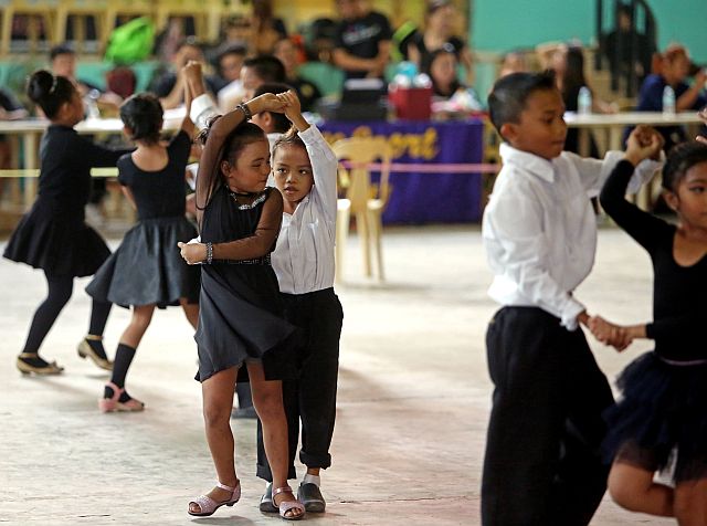 Children from different barangays in Cebu City groove in the 6th edition of the Cebu City Sports Commission 6th weekly dancesport competition held yesterday at the Lahug Elementary School. (CDN PHOTO/LITO TECSON)
