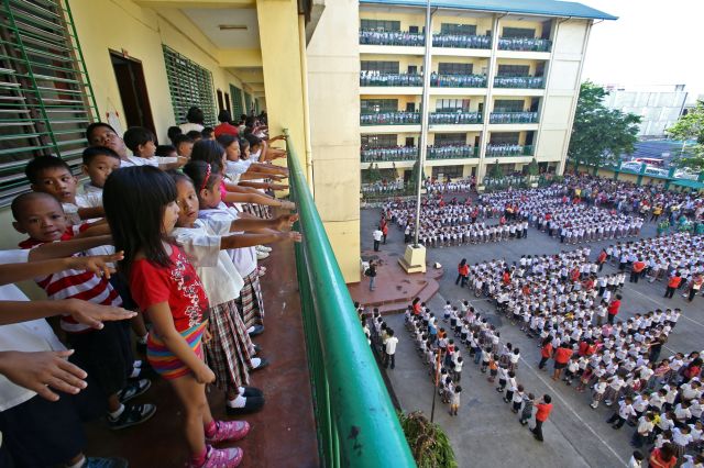 A typical scene during school opening, with students participating in the flag raising ceremony. (CDN FILE PHOTO)