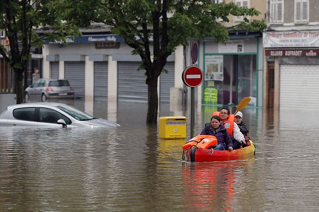 Residents use a canoe to evacuate in downtown Nemours, 50 miles south of Paris on Thursday. (AP)