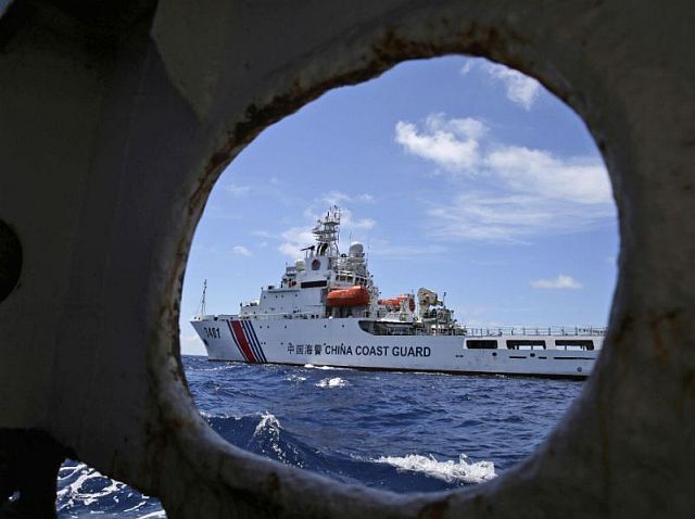 A Chinese Coast Guard ship attempts to block a Philippine government vessel as the latter tries to enter Second Thomas Shoal in the South China Sea to relieve Philippine troops and resupply provisions in this May 29, 2014 photo. (AP)