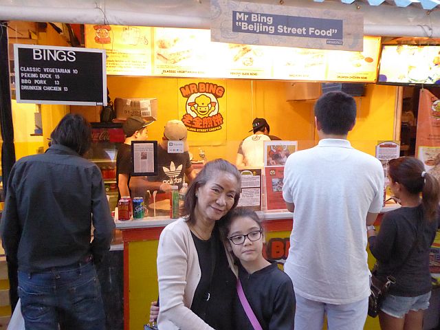 The writer and Sabrina infront of  Mr. Bing’s food stall.