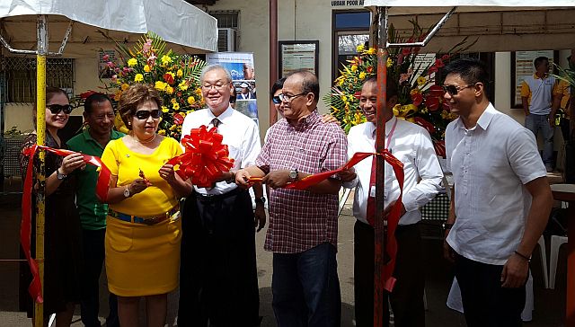 Multi-stake Public Affairs Director Gomez Siady, assisted by Mayor Paz Radaza and Vice Mayor Marcial Ycong, cuts the ribbon to open the Family History Exhibit. Witnessing are (from left) Mandaue Stake Public Affairs Director Dr. Mary Ann Ompad-Duero, City Councilor Cipriano Flores, Stake President Romeo Duero and Councilor James Fantone.  (CDN PHOTO/NORMAN MENDOZA)