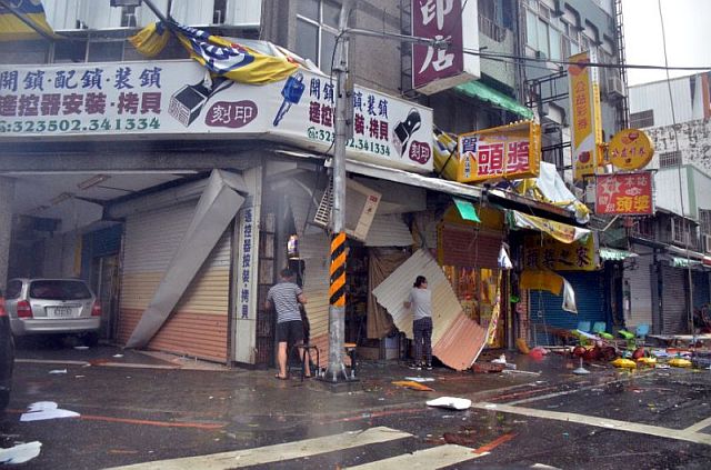 Debris scatter in front of a shop with broken shutters caused by strong winds of Super Typhoon Nepartak in Taitung, Taiwan. AFP