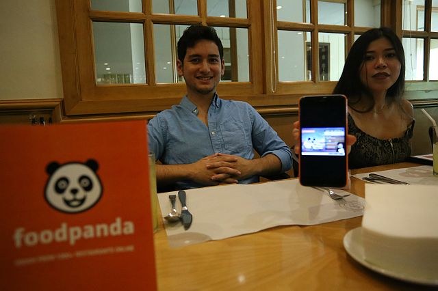 Seby Pelaez, head of Business Development and Mitz Jao, marketing manager of  Foodpanda.Ph show their promotional campaign and services to mark the company's first anniversary. (CDN PHOTO/LITO TECSON)