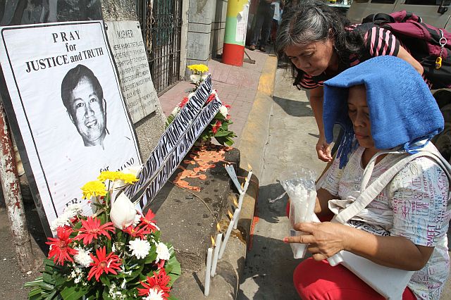IN MEMORIAM. Members of the militant group Bagong Alyansang Makabayan (Bayan) light candles and offer flowers at the marker in Barangay Tisa, Cebu City where Redemptorist priest Fr. Rudy Romano was abducted on July 11, 1985. Fr. Rudy, who remains missing 31 years later, has been accepted as dead by his family and the Redemptorist community.  CDN PHOTO/JUNJIE MENDOZA