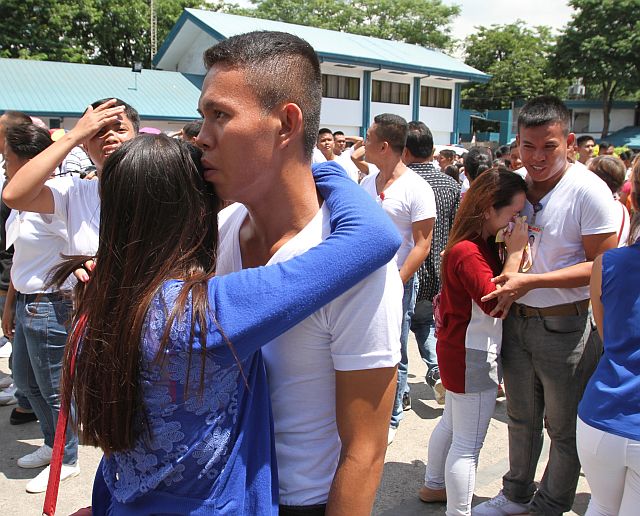 Some of the new police recruits are congratulated by their loved ones  them after their oath-taking in Camp Sergio Osmeña Sr. (CDN PHOTO/JUNJIE MENDOZA)