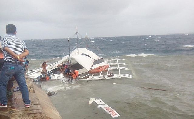 Remaining passengers and crew members of MB Nathan Express from Olango Island hurriedly jump off the boat as it was about to sink at the Hilton Wharf in Punta Engaño, Lapu-Lapu City as strong winds and waves slammed the vessel at past 2 p.m. yesterday. (CDN PHOTO/NORMAN MENDOZA)
