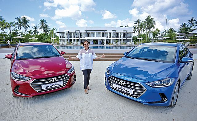 HARI president and CEO Maria Fe Perez-Agudo, with two units of the all-new Elantra, welcomes the media to the Kandaya Resort in Daanbantayan town, northern Cebu. 