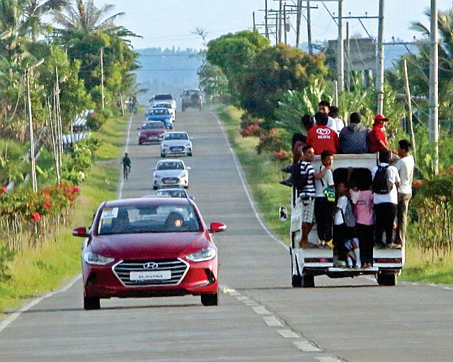 Members of the motoring media drive the Elantra through a straight stretch of road in northern Cebu.  
