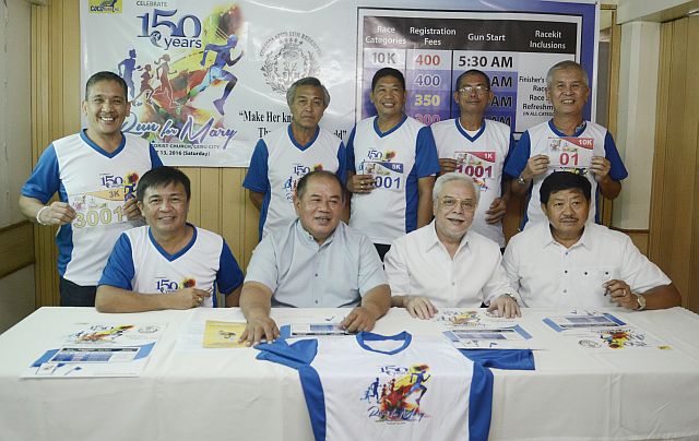 Race director Joel Juarez (seated, leftmost) and Fr. Cris Mostajo (seated, 2nd from left) lead the launching of the Run for Mary footrace scheduled on Aug. 13 at the grounds of the Redemptorist Church in Cebu City. CDN PHOTO/CHRISTIAN MANINGO