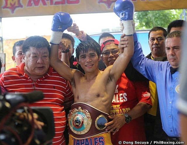 Marlon Tapales of the Philippines celebrates with his manager Rex ‘Wakee’ Salud moments after knocking out former two-time world champion Pong Luang Sor Singyu to annex the WBO bantamweight title yesterday in Thailand. (Dong Secuya of philboxing.com)