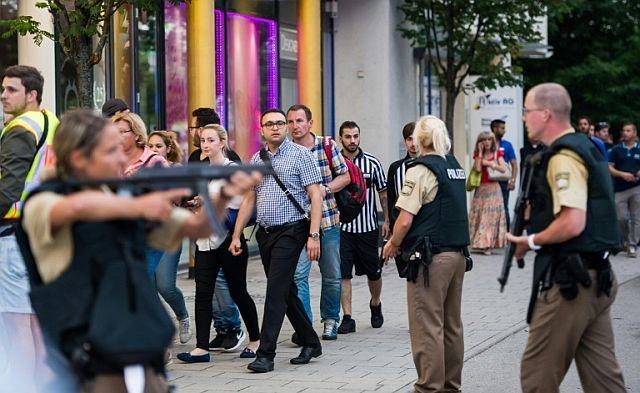 Shoppers rush out of the Olympia Einkaufzentrum shopping mall in Munich as the building was surrounded by armed police and emergency vehicles.