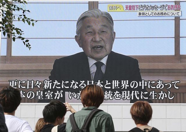 A screen displays Japanese Emperor Akihito delivering a speech in Tokyo, Monday. 