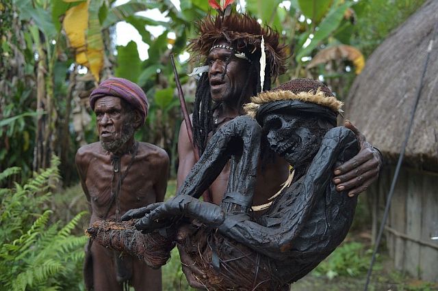 Tribe chief Eli Mabel holds the mummified remains of his ancestor, Agat Mamete Mabel, in the village of Wogi, in Wamena. (AFP)