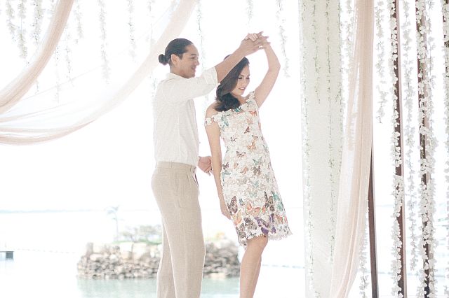 COUTURE ELEGANCE.  (On Alexander): Protacio  cotton polo shirt and bow tie, Philip Rodriguez linen slacks;  (on Leslie): Philip Rodriguez  off-the-shoulder embroidered lace with butterfly prints  and scallop hemline.