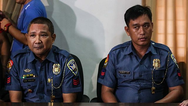 Highway Patrol Group personnel PO3 Jeremiah De Villa and PO2 Jonjie Manon-og at the Department of Justice in Manila to file their counteraffidavits. Both are facing charges for the murder of motorcycle rider John Dela Riarte. De Villa was found dead in Camp Crame yesterday morning. 