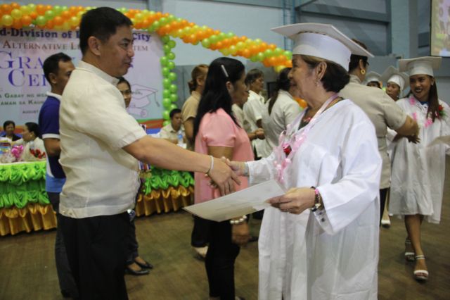 Pajo Barangay Captain Junard Chan congratulates Soledad dela Cruz, the oldest student of her batch.