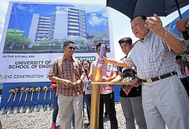 University of Cebu President Augusto Go places a document into the time capsule during the groundbreaking ceremony of its new engineering building in Cebu City. (CDN PHOTO/LITO TECSON)