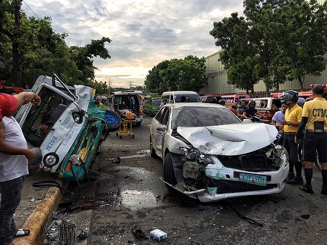 A badly mangled Toyota Camry settles in the middle of the street after colliding with a multicab and a motorcycle in Barangay Ibo, Lapu-Lapu City on Saturday morning. (CDN PHOTO/TONEE DESPOJO)