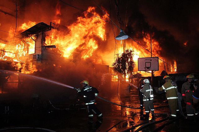 Firefighters battle last night’s raging fire in Barangay Day-as, Cebu City. (CDN PHOTO/JUNJIE MENDOZA)