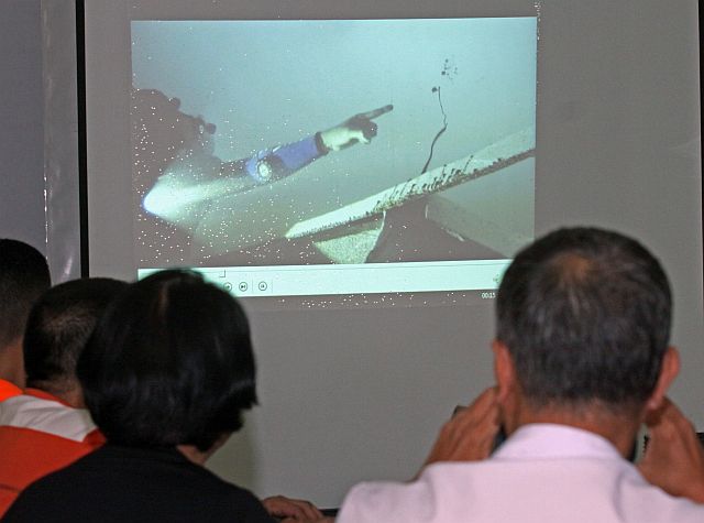Marine biologists and local officials look at the video of the remains of the St. Thomas Aquinas vessel that sank deep in the waters off Lauis Ledge as Coast Guard personnel examine the damaged hull of the Sulpicio Express Siete in these August 2013 CDN file photos.