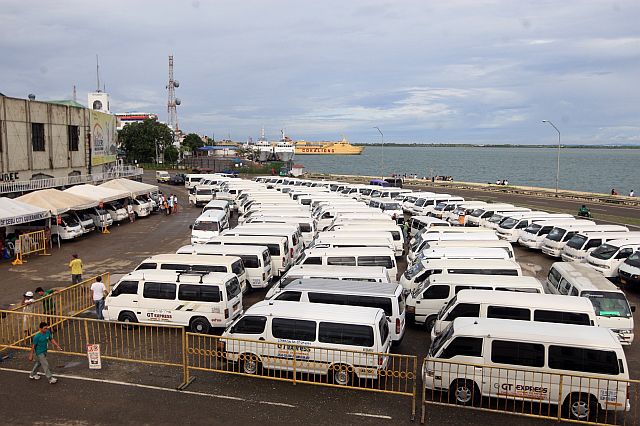 After initially complaining about their transfer to the Compania Maritima building vacant site, the van-for-hire operators now want to return to it, citing passenger complaints about their present site at SM Seaside City. (CDN File Photo)