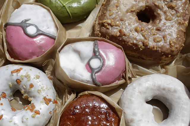Pecha Berry Pokeseed doughnuts, top left and center, are displayed in a box of doughnuts from Doughnut Plant, in New York. (AP PHOTO)
